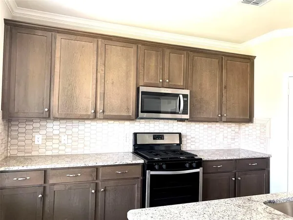 a kitchen with a sink stove and microwave