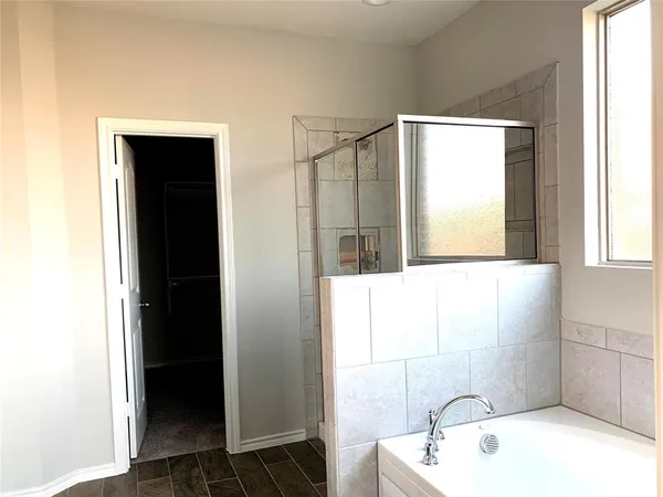 a bathroom with a bathtub and a shower