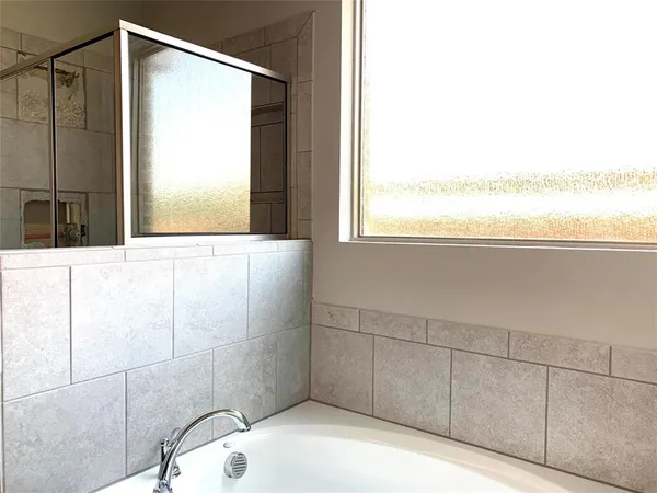 a bathroom with a shower and a window