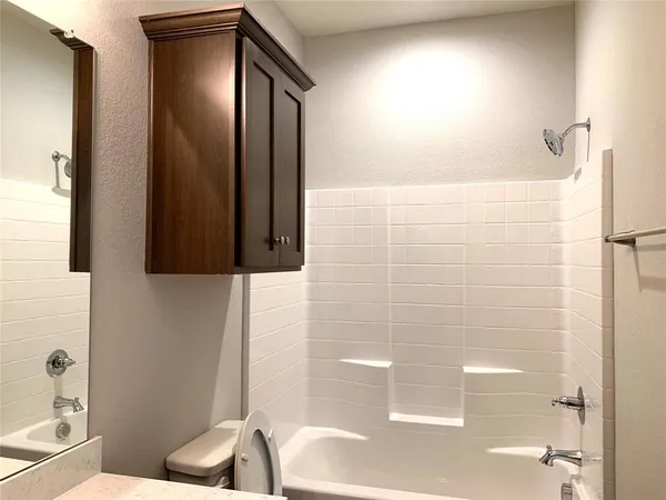 a bathroom with a bathtub and a shower