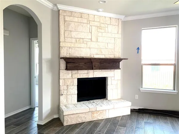 a living room with a fireplace and a window