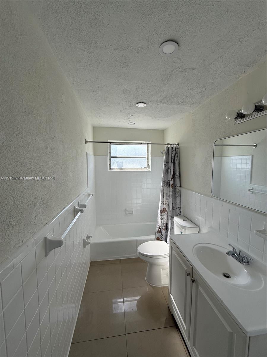 16890 Northeast 21st Avenue, Unit 1 North Miami Beach, FL 33162 - Photo 4 of 7 a bathroom with a sink a toilet and shower