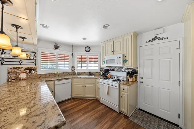 a kitchen with stainless steel appliances granite countertop a stove and a sink