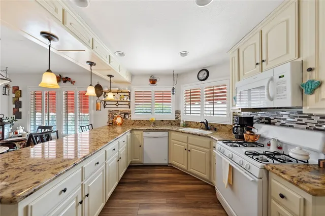 a large white kitchen with a large window