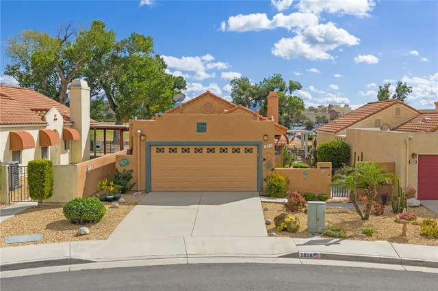 a view of a house with entertaining space and a car parked in front of it