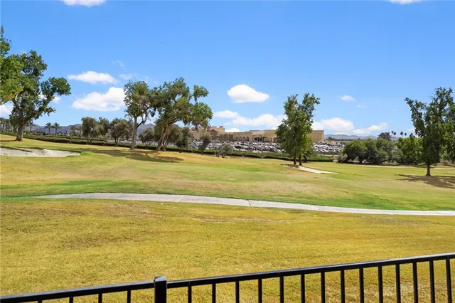 a view of a patio with table and chairs potted plants with wooden floor and fence