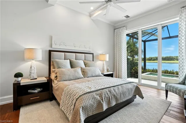 a bedroom with a large bed and a large window