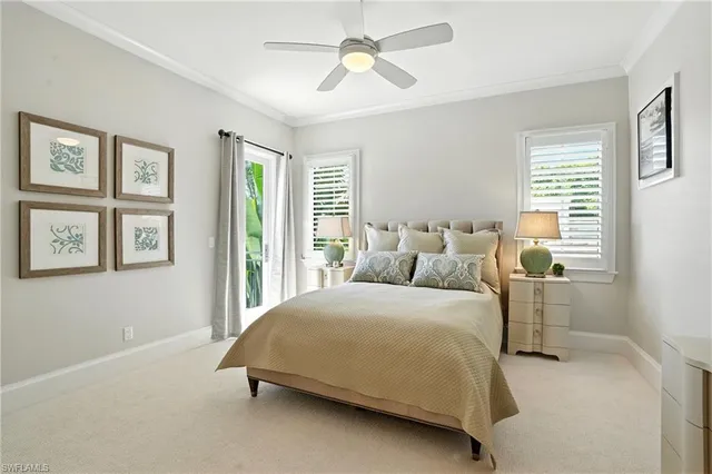 a bedroom with a bed chandelier and window
