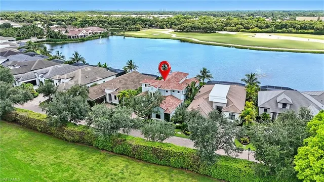 an aerial view of a house with a lake view