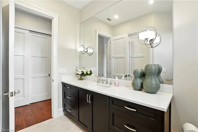 a bathroom with a double vanity sink and a mirror