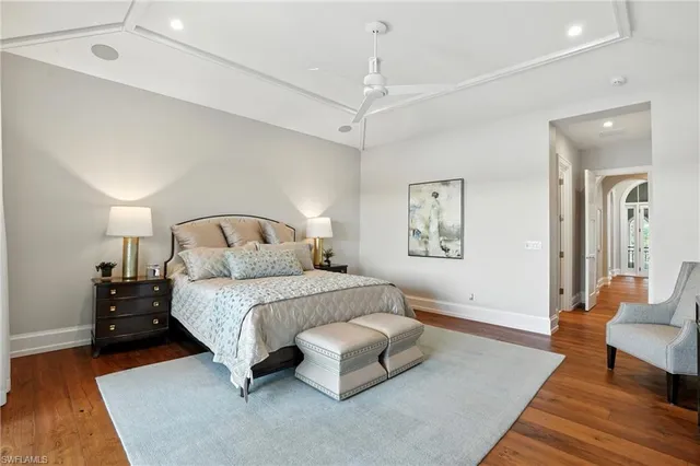 a bedroom with a bed mirror and couch