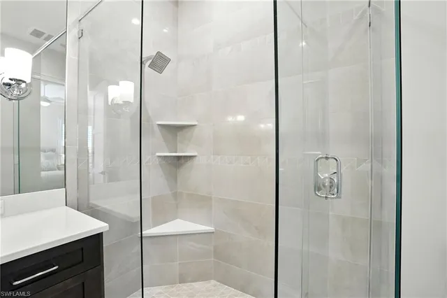 a bathroom with a shower and a mirror