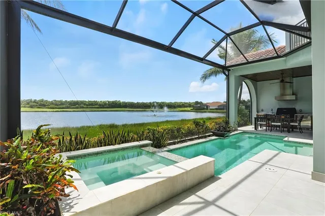 a view of swimming pool with a couches in a patio