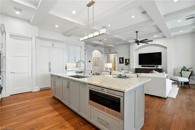 a large kitchen with kitchen island a sink and a stove top oven