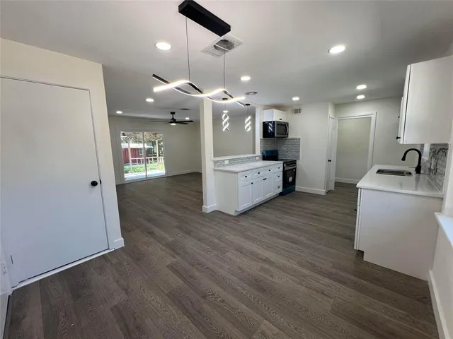 a view of hallway with wooden floor