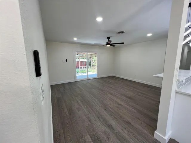 a view of a kitchen and a sink with wooden floor