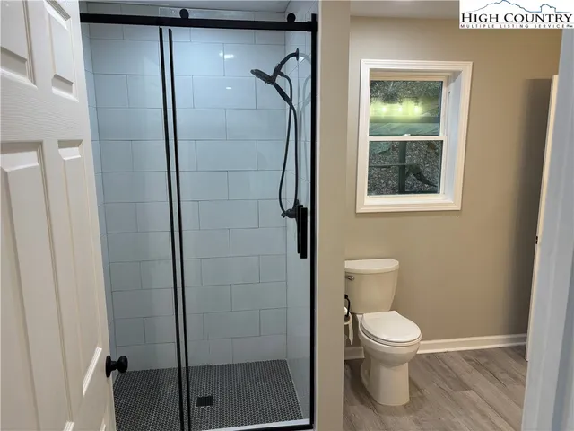 a bathroom with a toilet and a shower
