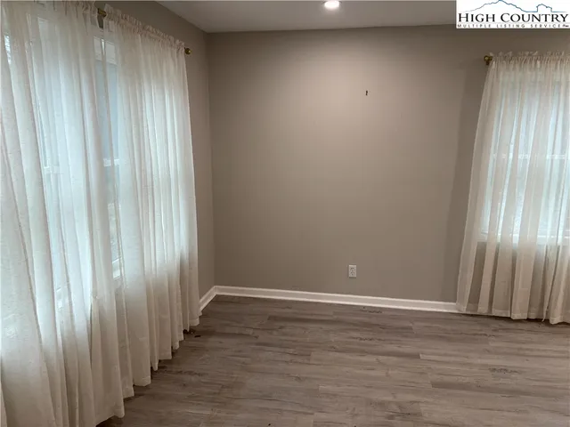 a view of a room with wooden floor
