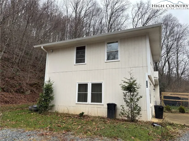 a house that has a tree in front of the house