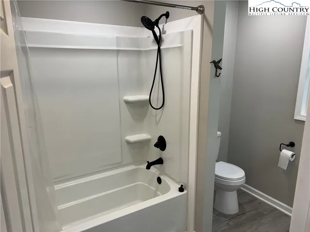 a bathroom with a toilet and a shower