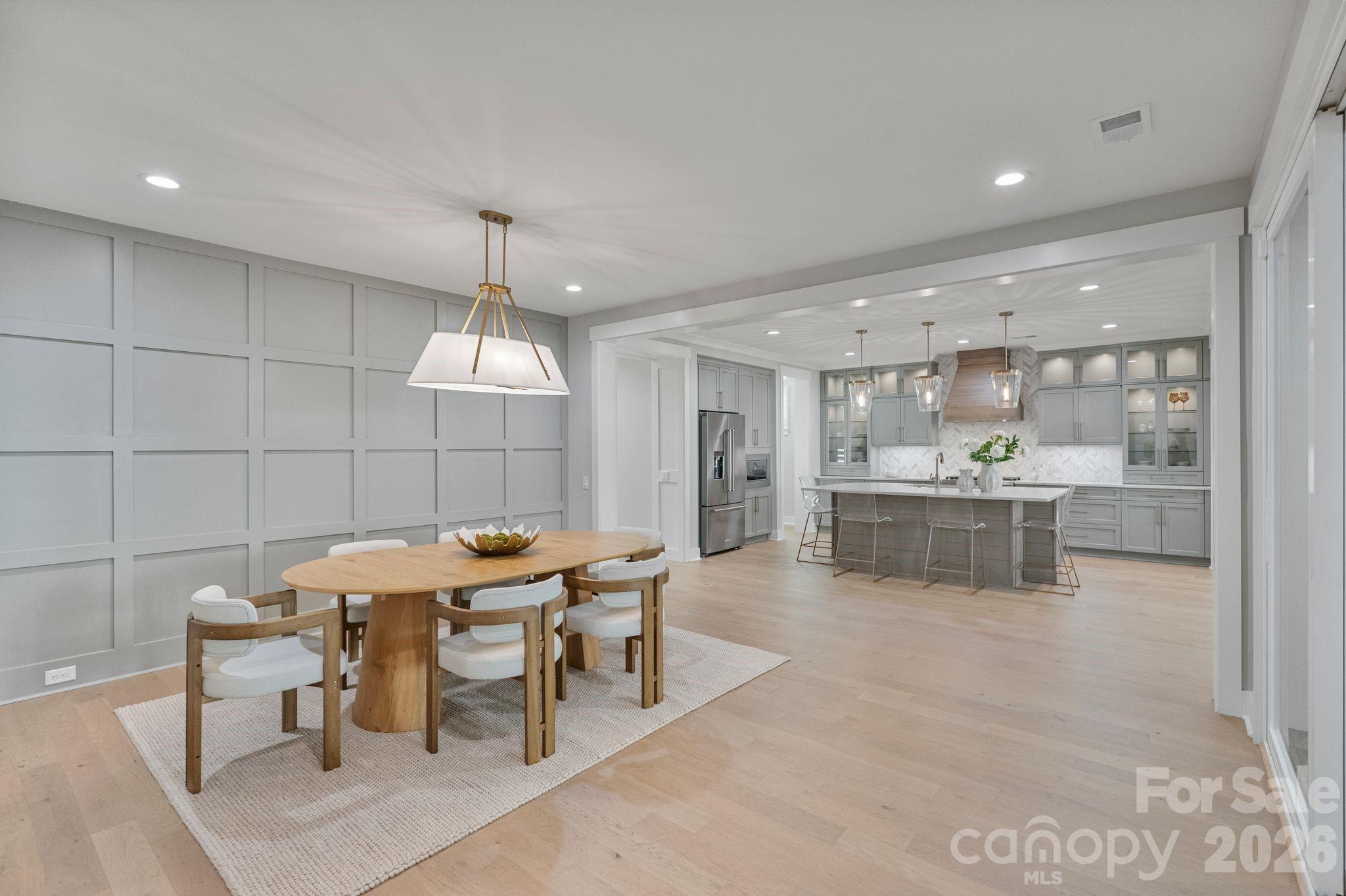 4031 Pritchard Place Fort Mill, SC 29715 - Photo 11 of 48 a dining hall with stainless steel appliances kitchen island granite countertop a table and chairs