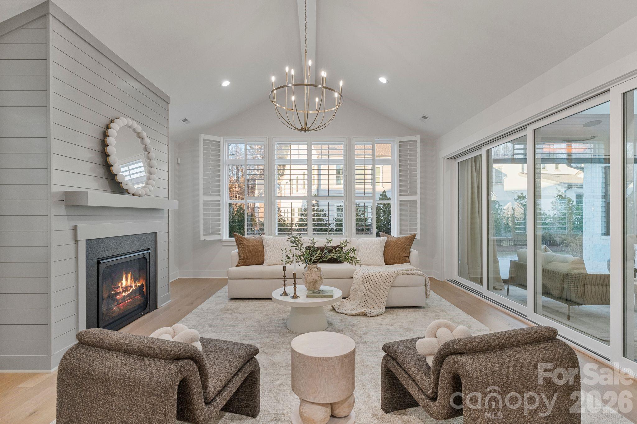 4031 Pritchard Place Fort Mill, SC 29715 - Photo 14 of 48 a living room with furniture a fireplace and a large window
