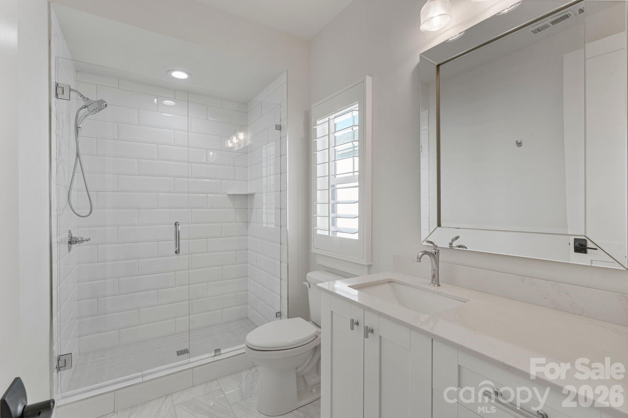 4031 Pritchard Place Fort Mill, SC 29715 - Photo 40 of 48 a bathroom with a shower sink vanity mirror and toilet