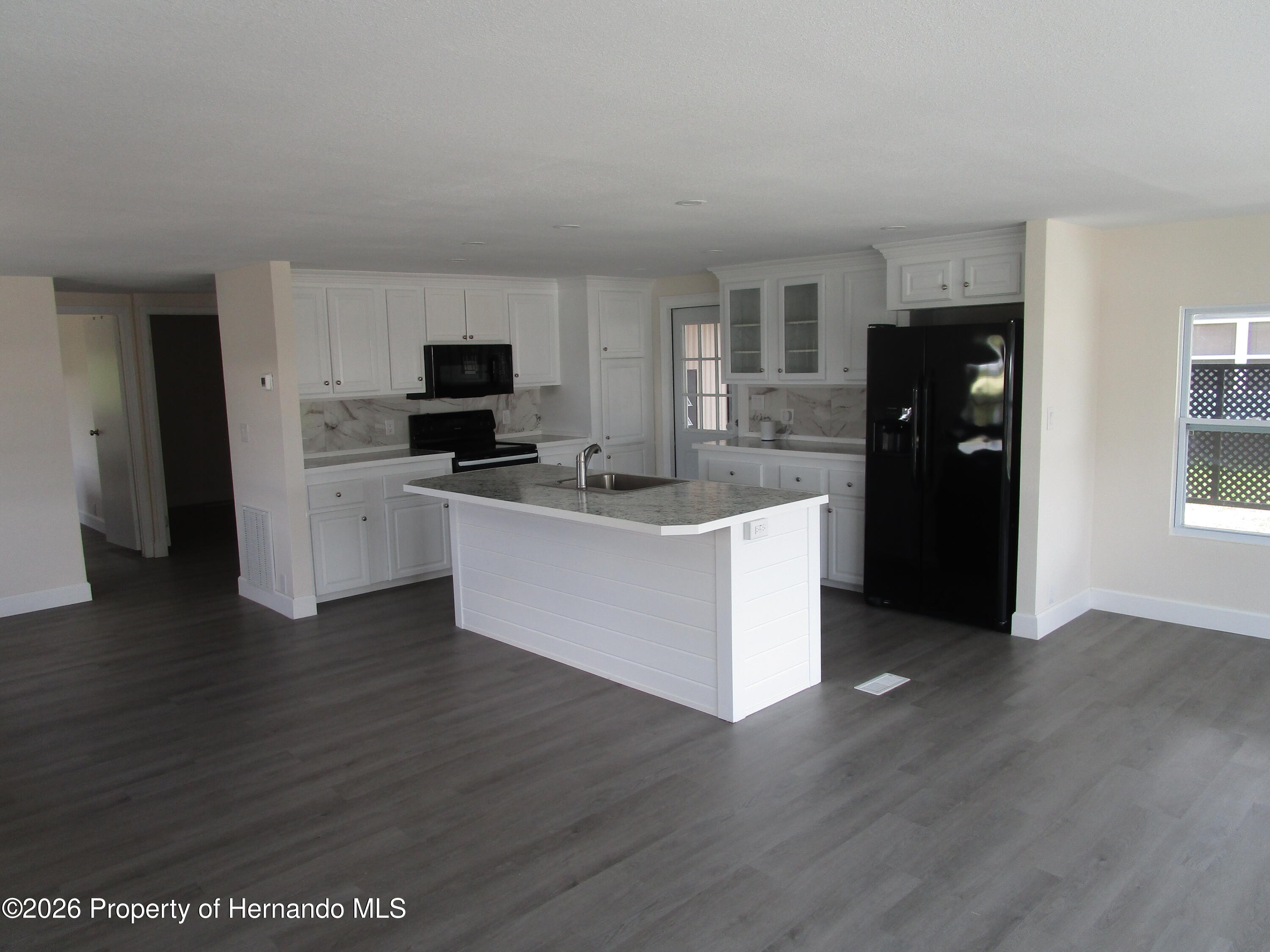 14790 Rialto Avenue, Unit 3 Brooksville, FL 34613 - Photo 6 of 15 a kitchen with stainless steel appliances a refrigerator and a stove top oven