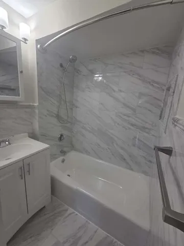 a bathroom with a bathtub and a sink
