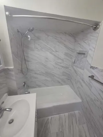 a bathroom with a sink and shower