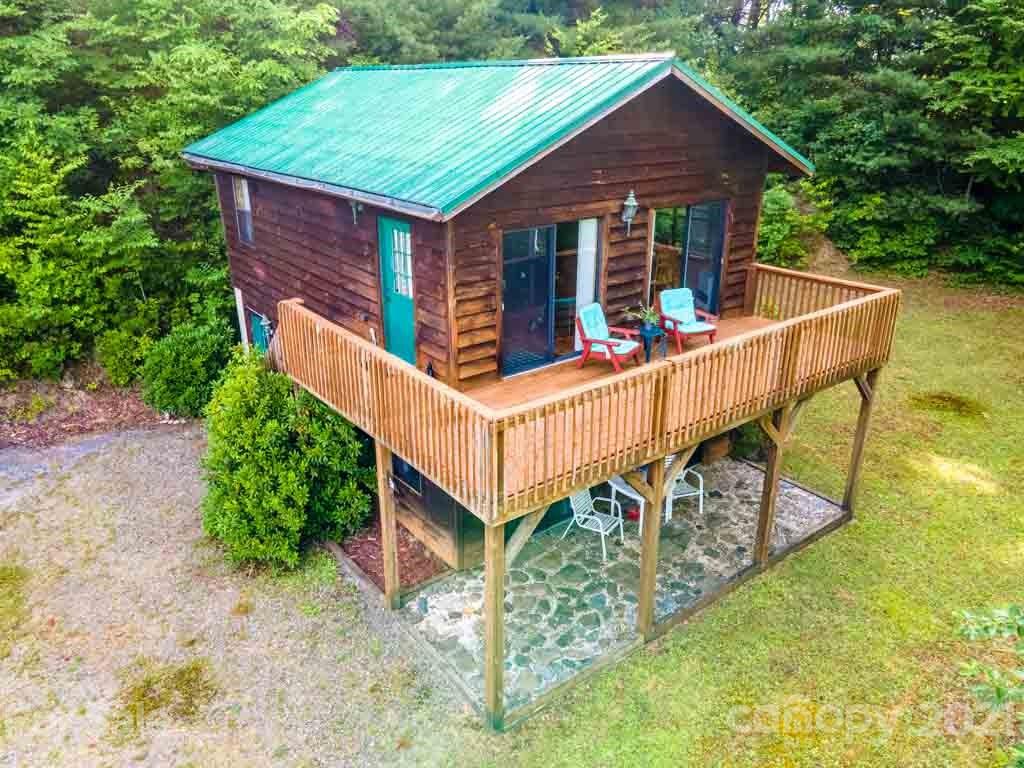 195 Mopey Maple Road Waynesville, NC 28785 - Photo 3 of 23 a view of a house with wooden deck and trees