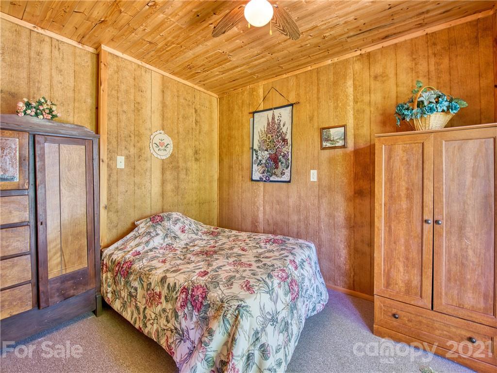 195 Mopey Maple Road Waynesville, NC 28785 - Photo 22 of 23 a bedroom with a bed and a window