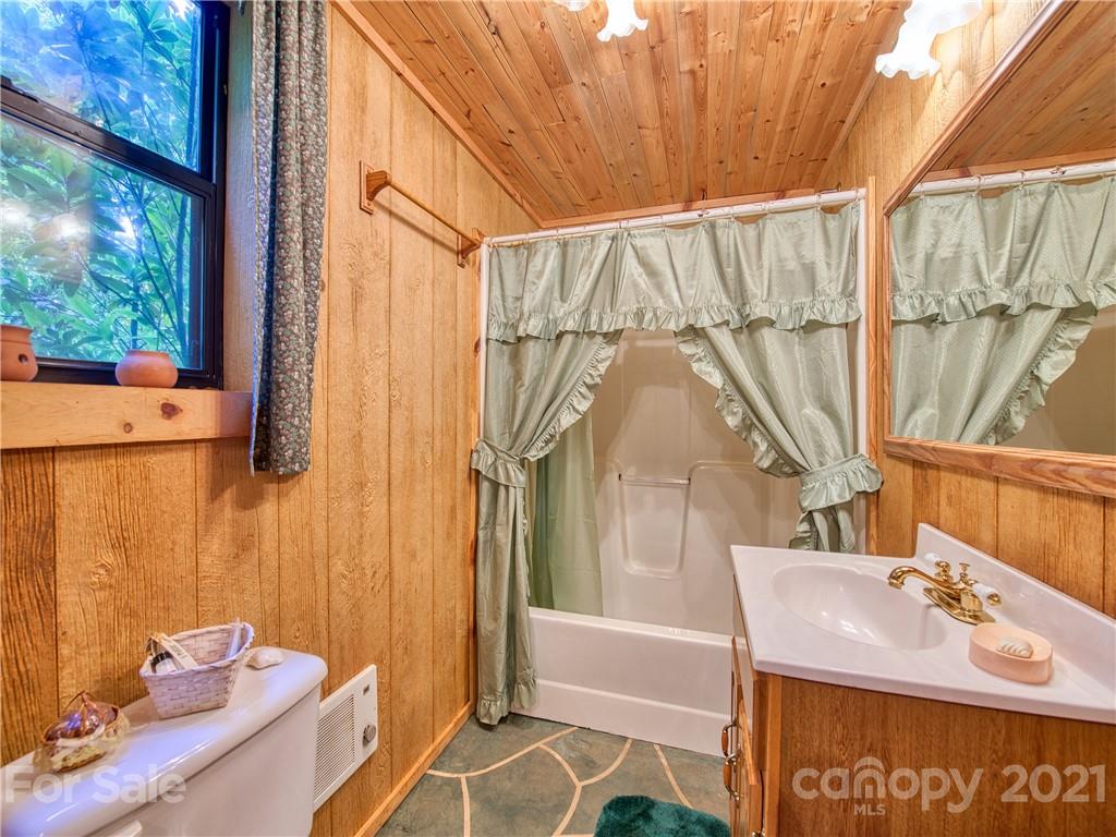 195 Mopey Maple Road Waynesville, NC 28785 - Photo 23 of 23 a bathroom with a sink and a mirror