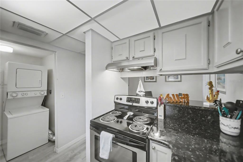 6157 Midnight Pass Road, Unit E23 Sarasota, FL 34242 - Photo 18 of 49 a kitchen with stainless steel appliances granite countertop a stove and a cabinets