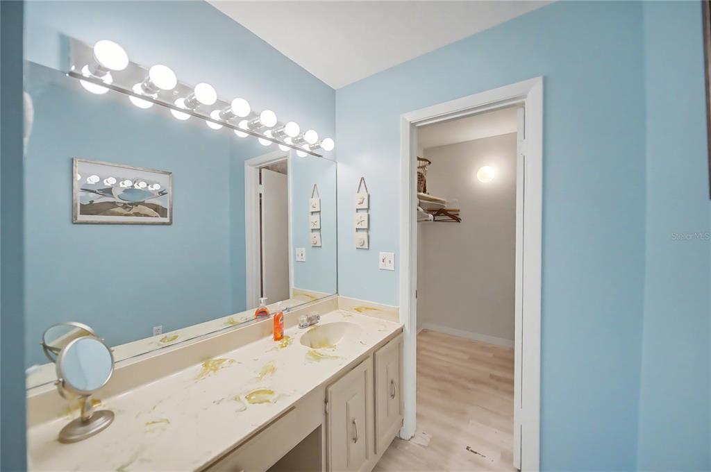 6157 Midnight Pass Road, Unit E23 Sarasota, FL 34242 - Photo 22 of 49 a bathroom with a sink vanity and a mirror
