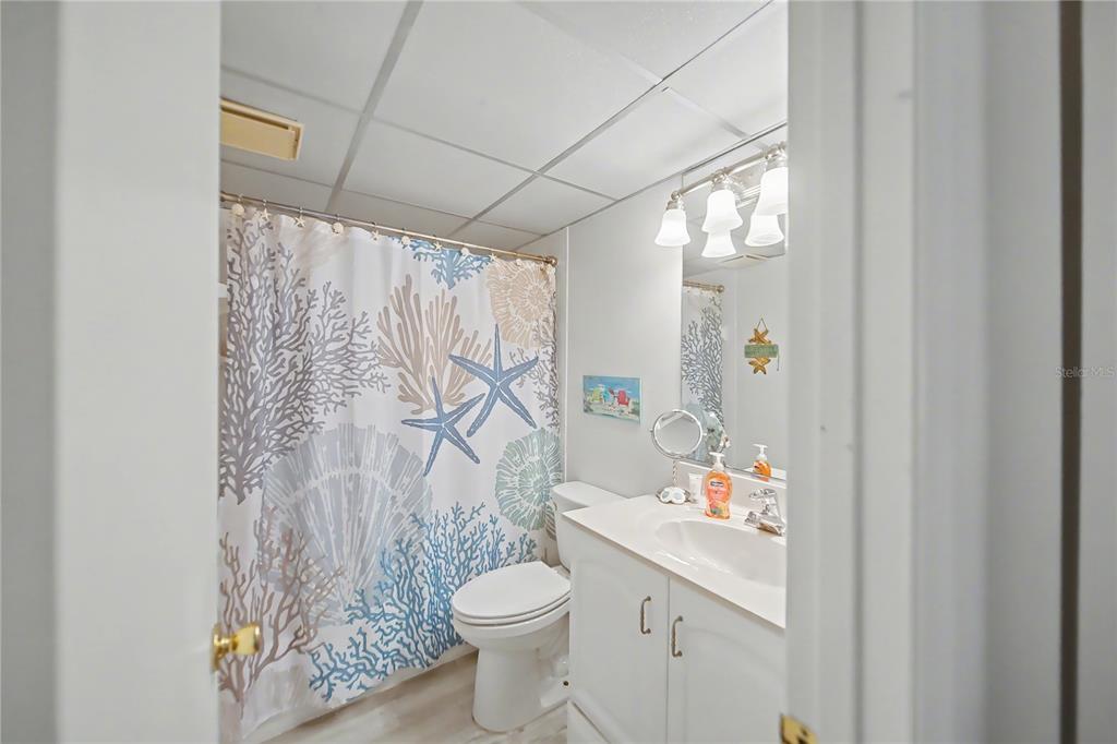 6157 Midnight Pass Road, Unit E23 Sarasota, FL 34242 - Photo 25 of 49 a bathroom with a sink toilet and shower