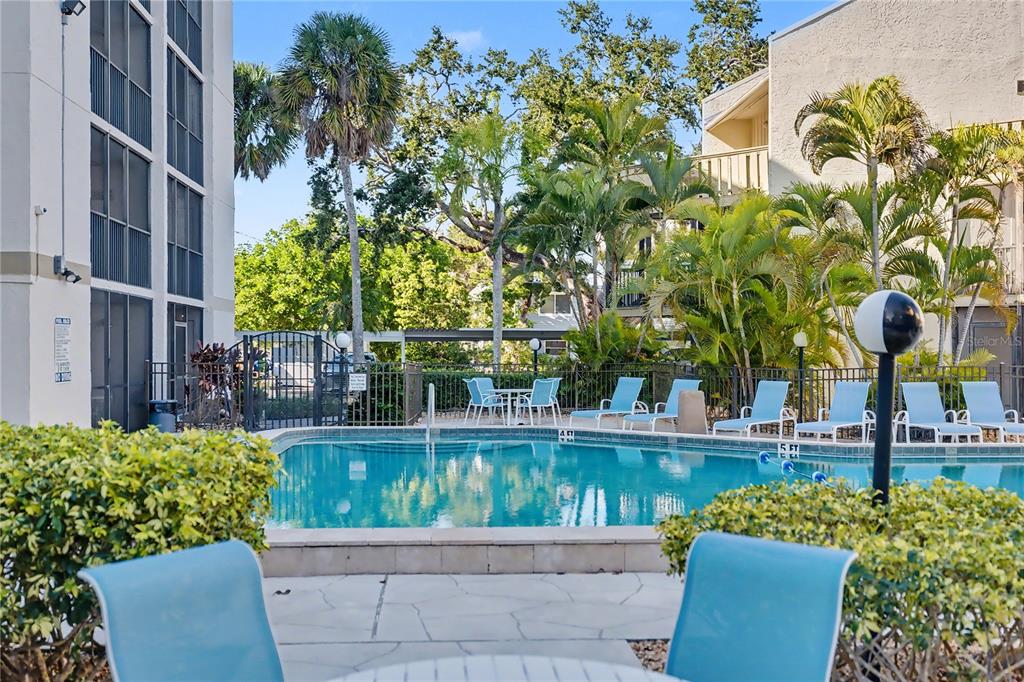 6157 Midnight Pass Road, Unit E23 Sarasota, FL 34242 - Photo 36 of 49 front view of a house with a garden
