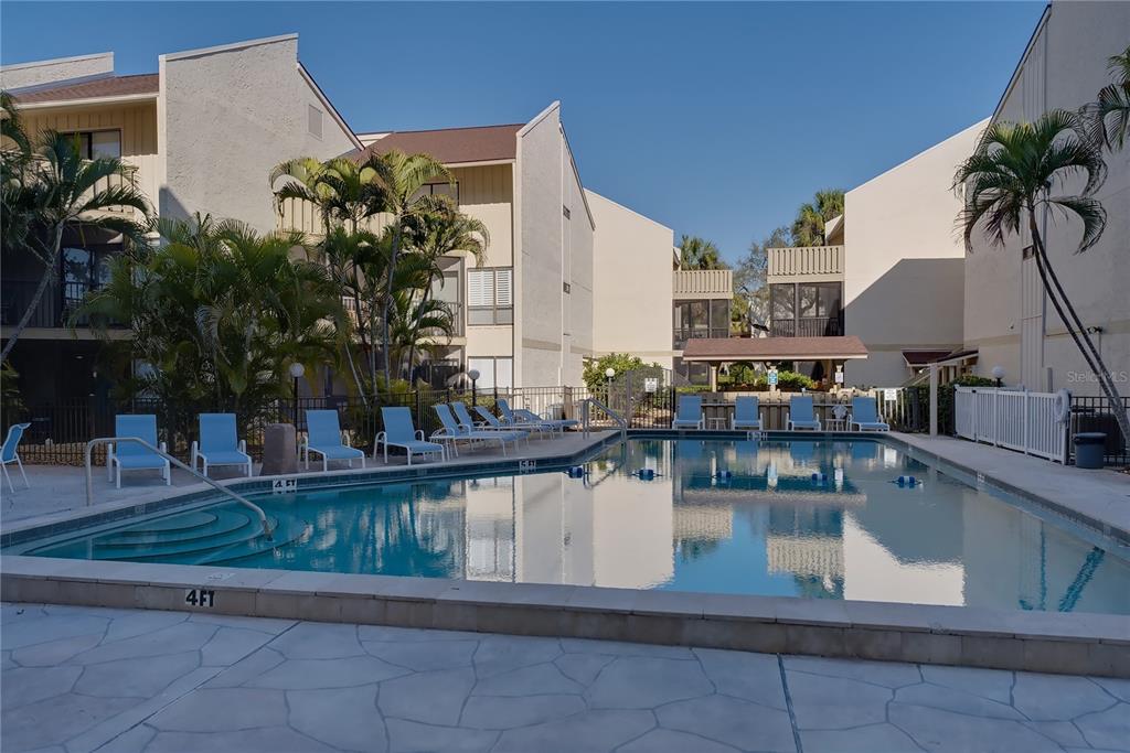 6157 Midnight Pass Road, Unit E23 Sarasota, FL 34242 - Photo 38 of 49 a view of a living room and kitchen
