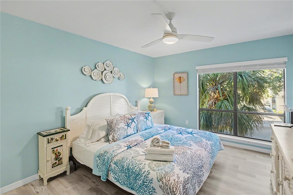 6157 Midnight Pass Road, Unit E23 Sarasota, FL 34242 - Photo 4 of 49 a bedroom with a bed and a large window