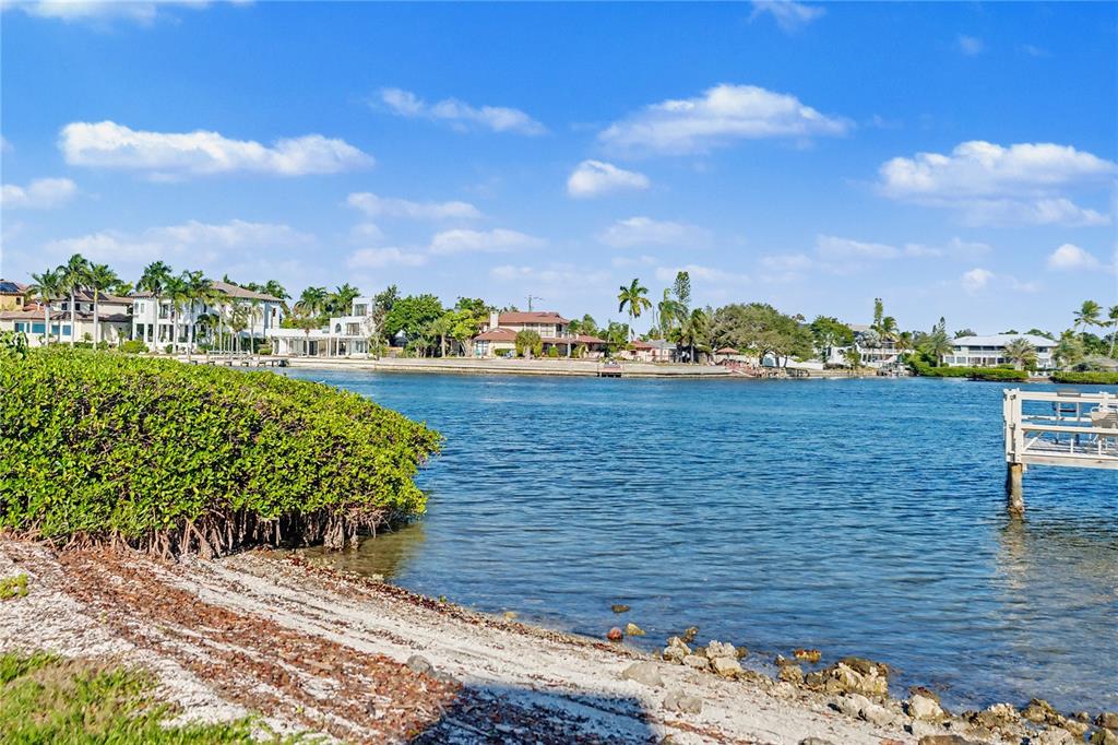 6157 Midnight Pass Road, Unit E23 Sarasota, FL 34242 - Photo 46 of 49 a view of a lake with a building in the background