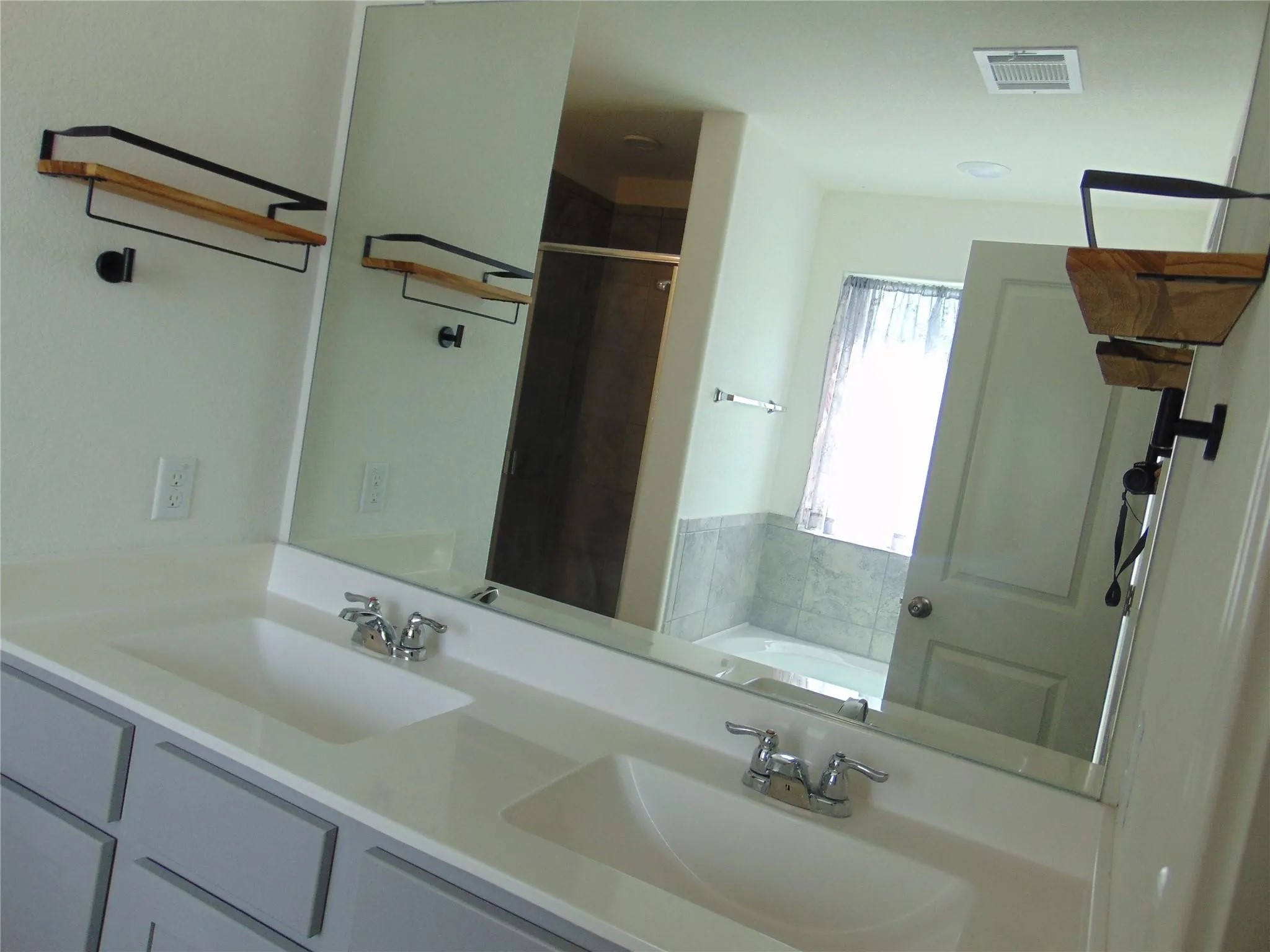 181 Crystal River Road Kyle, TX 78640 - Photo 5 of 9 a bathroom with a sink and a mirror