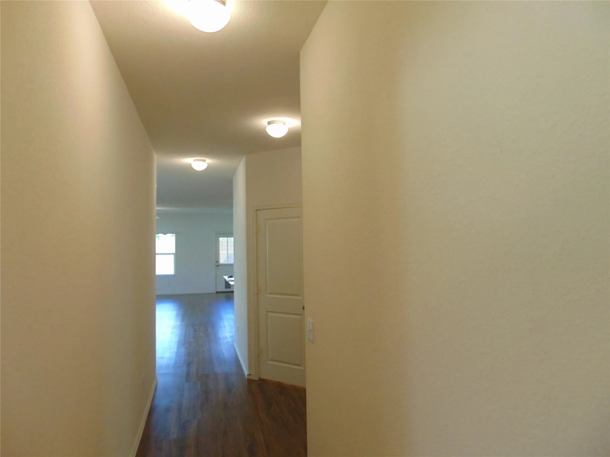 181 Crystal River Road Kyle, TX 78640 - Photo 6 of 9 a view of a hallway with wooden floor