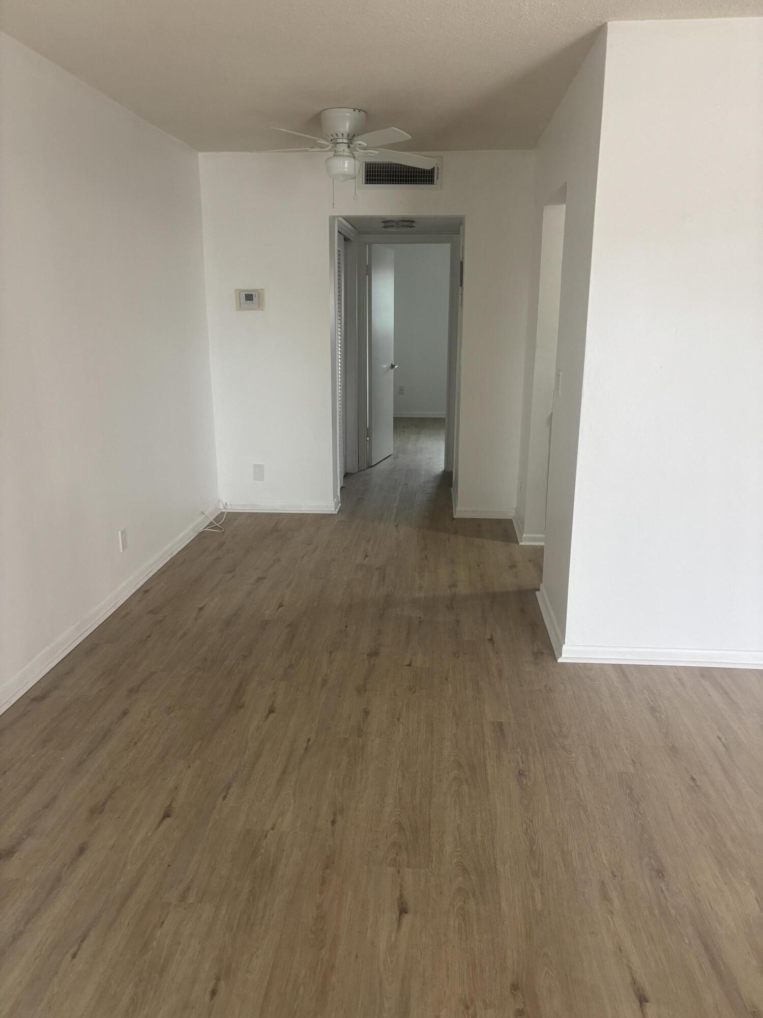 521 Northeast 45th Street Boca Raton, FL 33431 - Photo 5 of 17 a view of a hallway with wooden floor