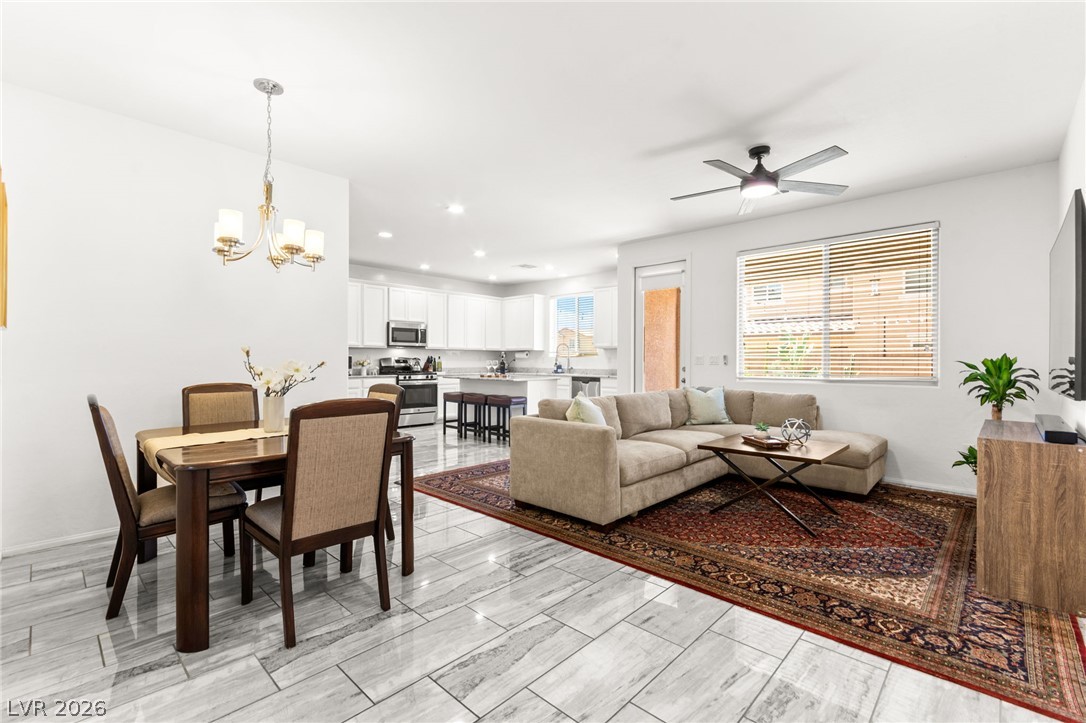 6435 Point Isabel Way Las Vegas, NV 89122 - Photo 54 of 57 An open floorplan seamlessly connects the dining area, living space, and a well-appointed kitchen.