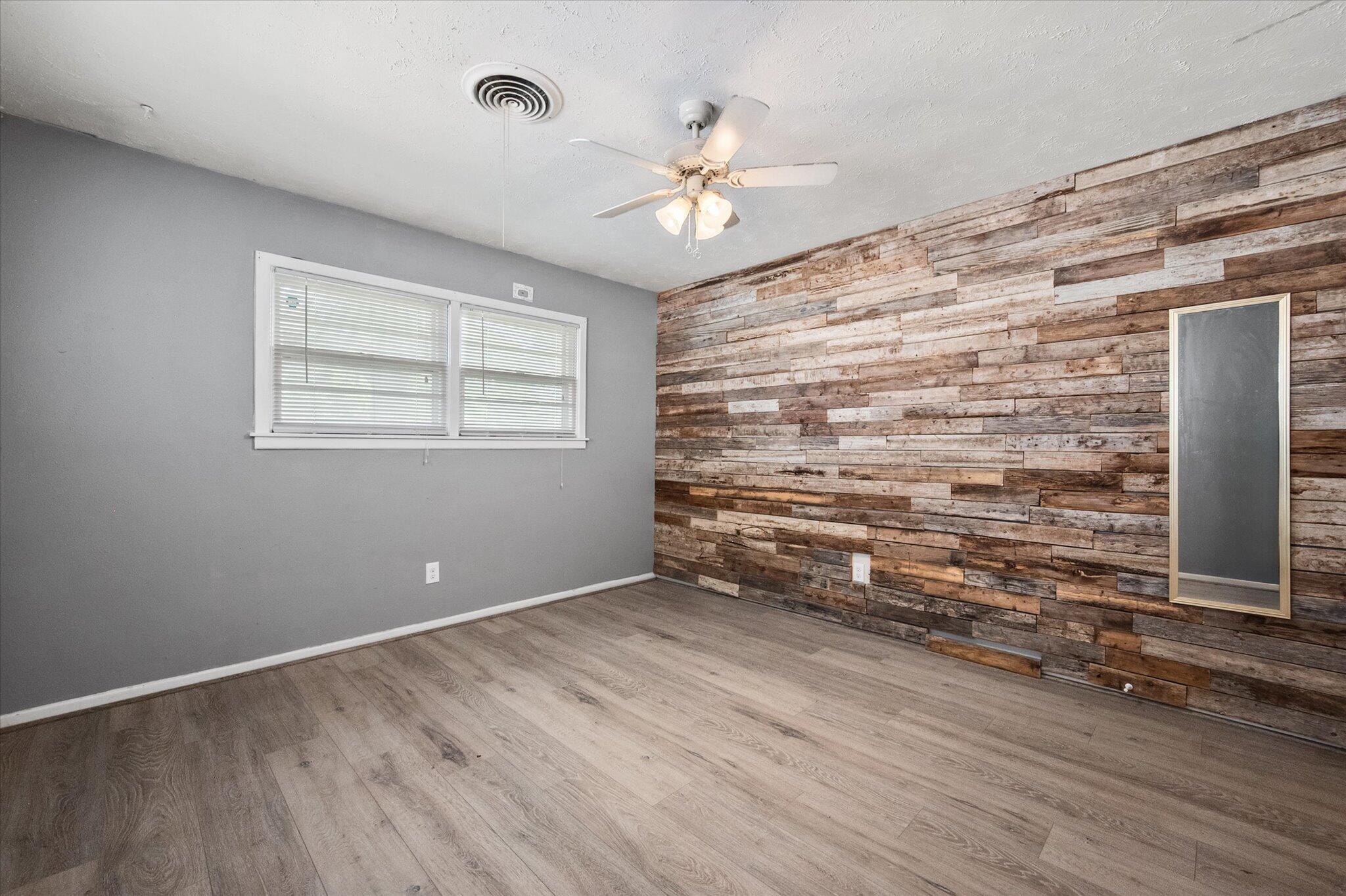4604 27th Street Lubbock, TX 79410 - Photo 12 of 36 wooden floor in an empty room with a window