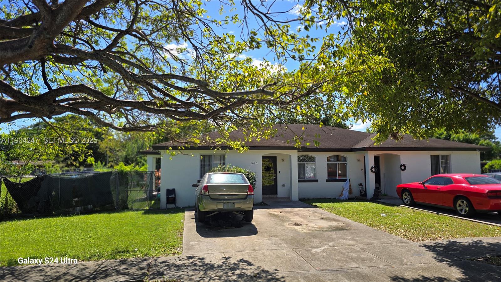12040 Southwest 215th Street Miami, FL 33170 - Photo 2 of 2 a front view of a house with garden