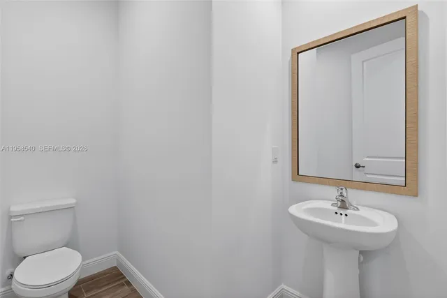 an empty room with a window and a ceiling fan