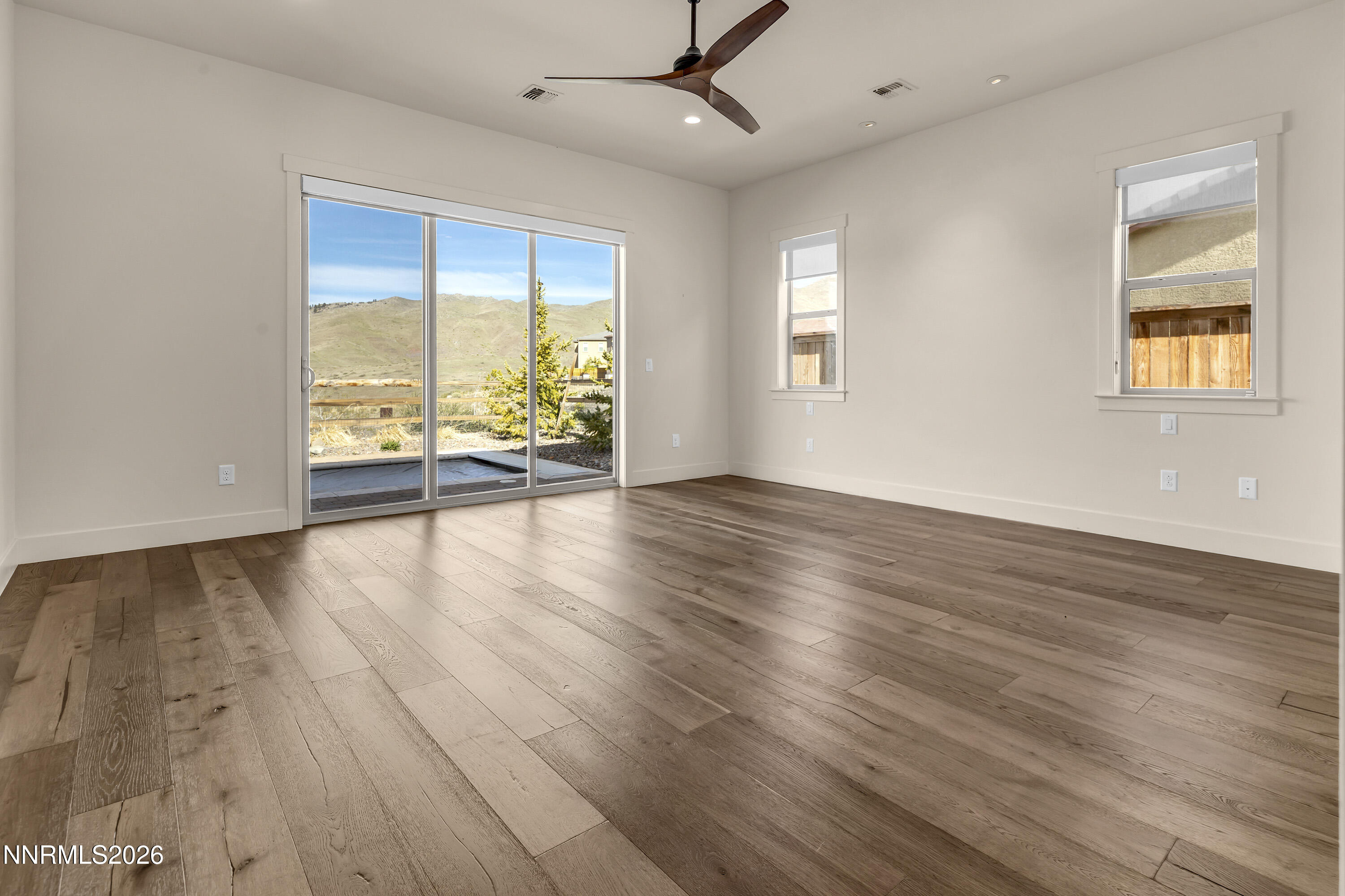 9219 Wild Skies Court Reno, NV 89523 - Photo 29 of 38 a view of an empty room with wooden floor and a window