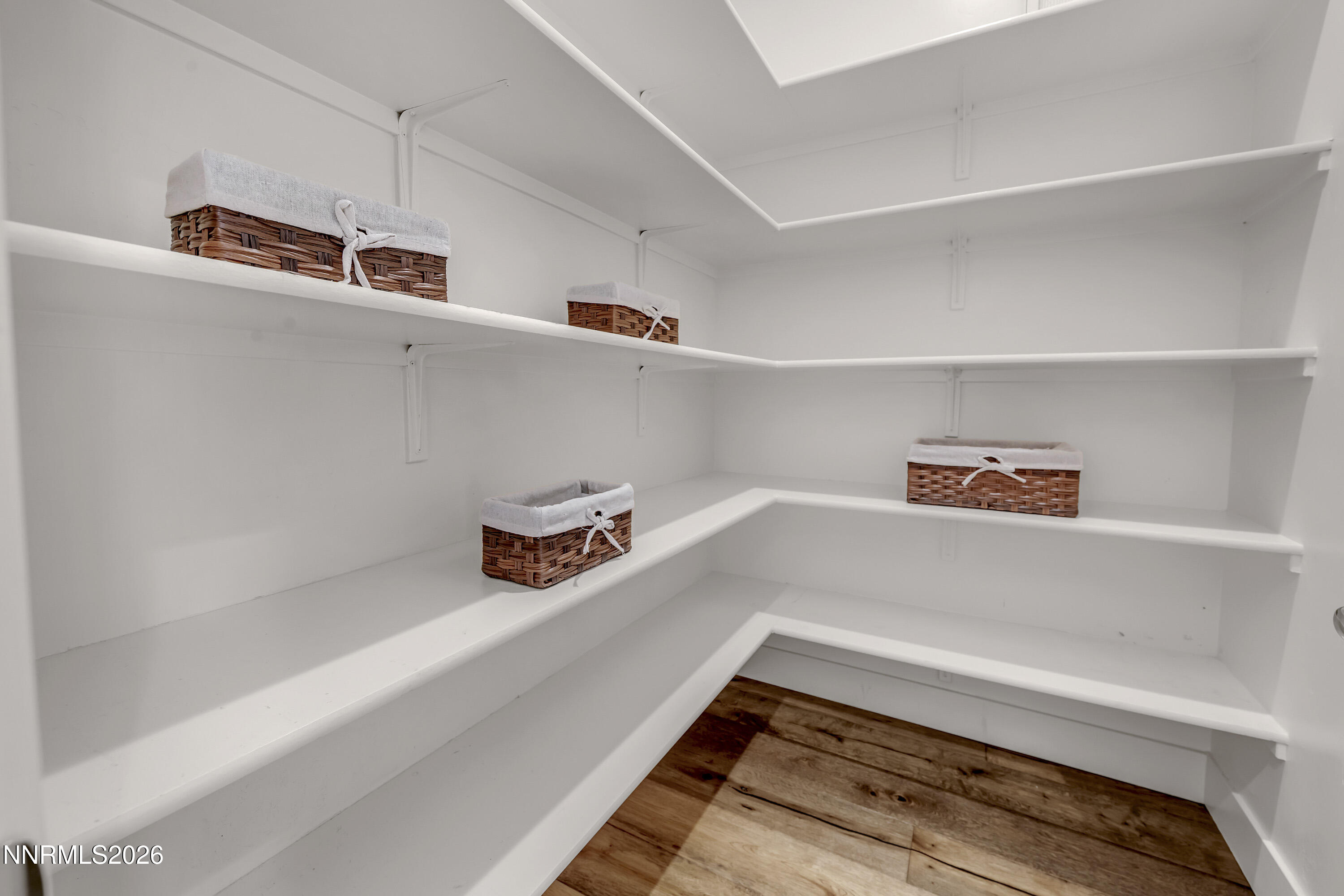 9219 Wild Skies Court Reno, NV 89523 - Photo 36 of 38 a hallway with a cabinet and wooden floor
