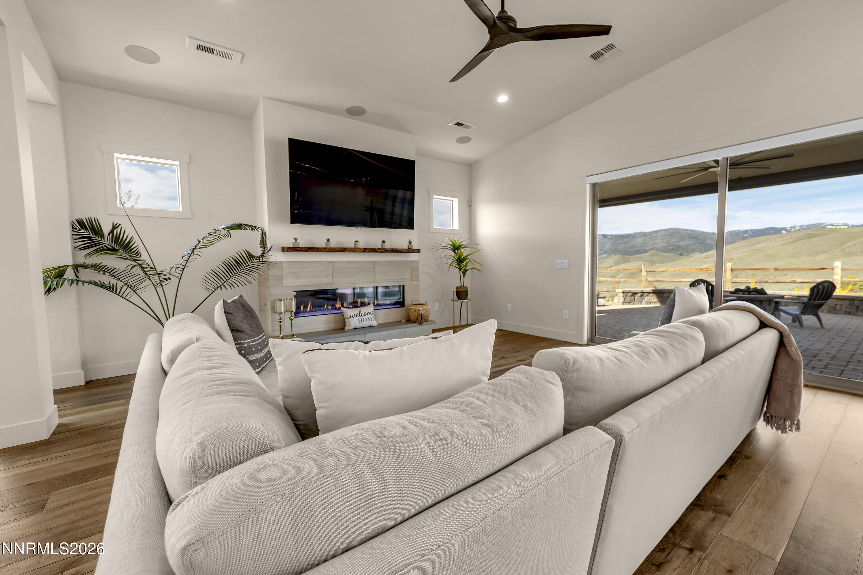 9219 Wild Skies Court Reno, NV 89523 - Photo 4 of 38 a living room with furniture flat screen tv and a large window